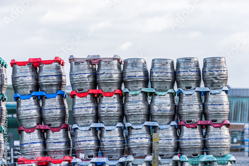 Shiny metal beer kegs barrels of beer stacked for dispatch photo