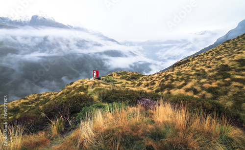 A small hut sits on the edge of a cliff above the Matukituki Valley in the Mt. Aspiring National Park on New Zealand's south island. photo