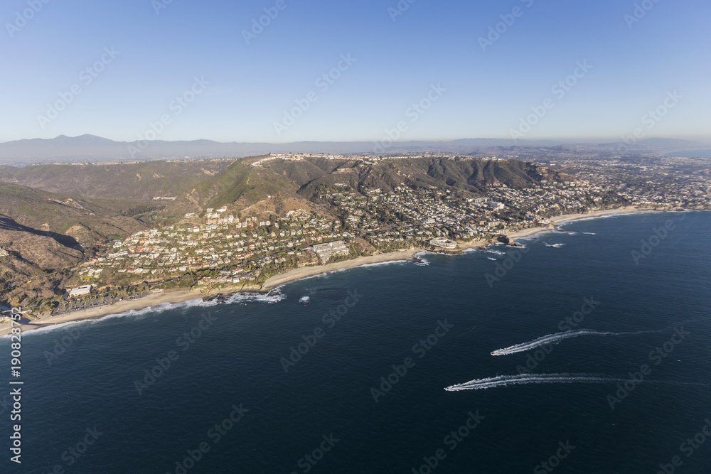 Aerial view of passing boats along the pacific coast near Laguna Beach in Orange County California.  