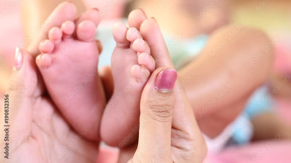 Newborn Baby's feet.Mother holding newborn baby legs for massage Newborn Baby's feet.Mother holding newborn baby legs for massage