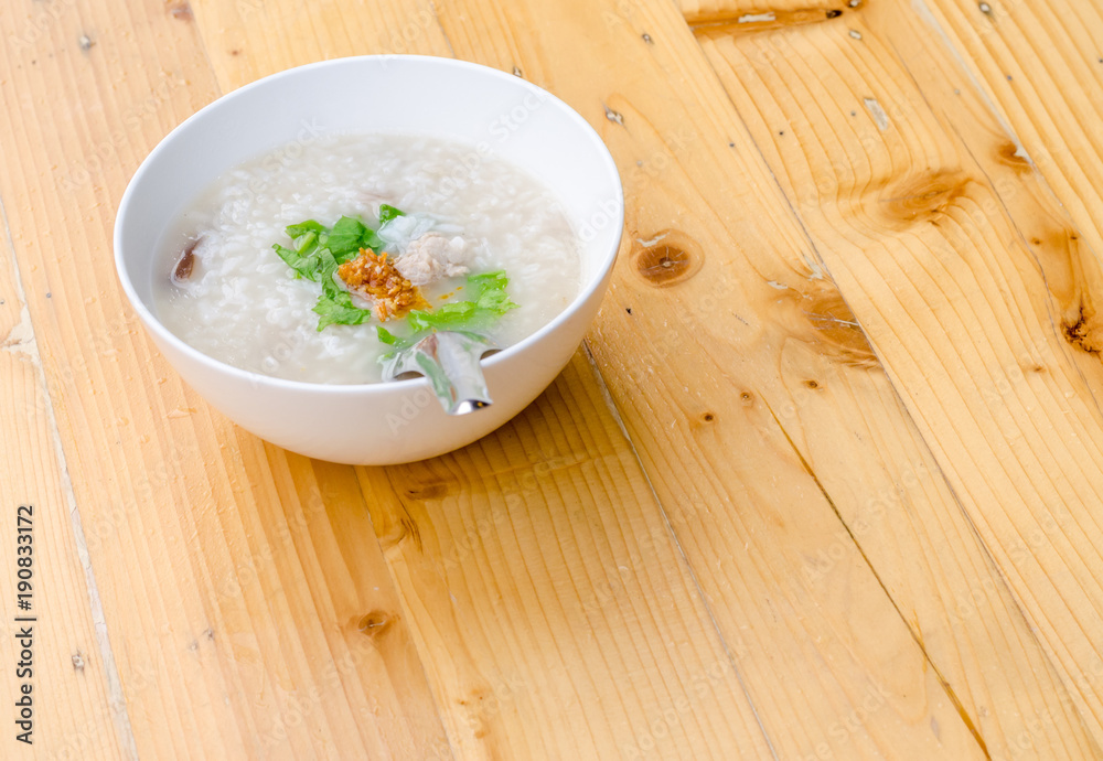 Congee with minced pork in white bowl, breakfast time Congee with minced pork in white bowl, breakfast time