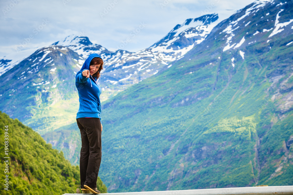 Naklejka premium Tourist woman enjoying mountains landscape in Norway.