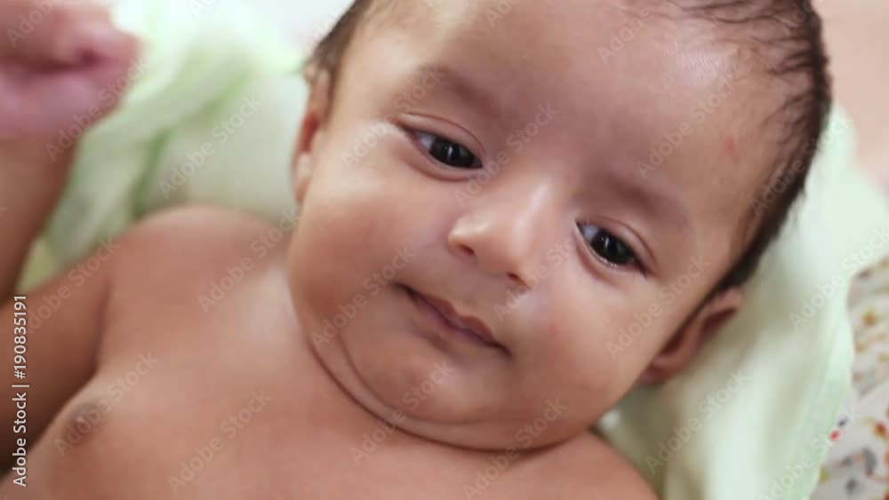Newborn baby closeup,playful,active,smiling Newborn baby closeup,playful,active,smiling