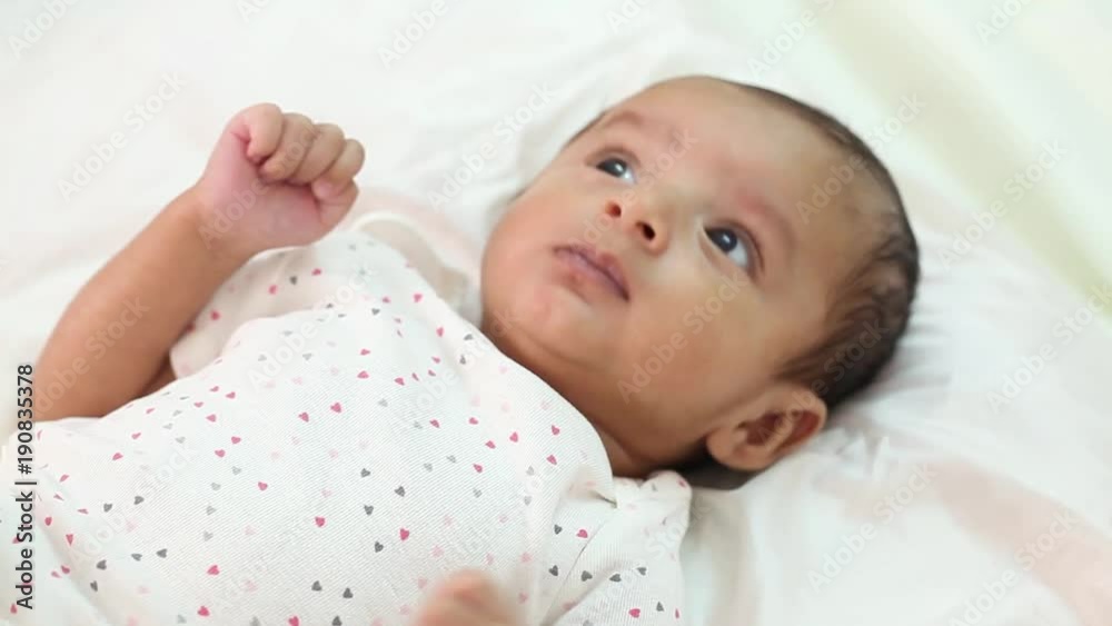Newborn baby closeup,playful,active,smiling Newborn baby closeup,playful,active,smiling