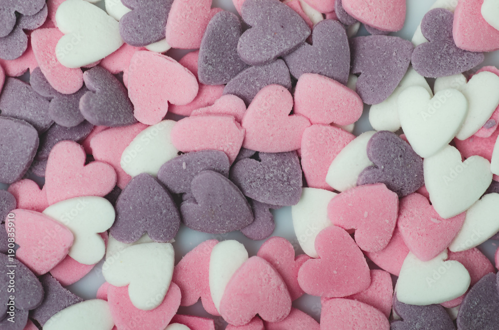 Full color Sugar sprinkled with dots a shape of the heart, an ornament for a pie and bakery products, a lot of splashes as a background. close up