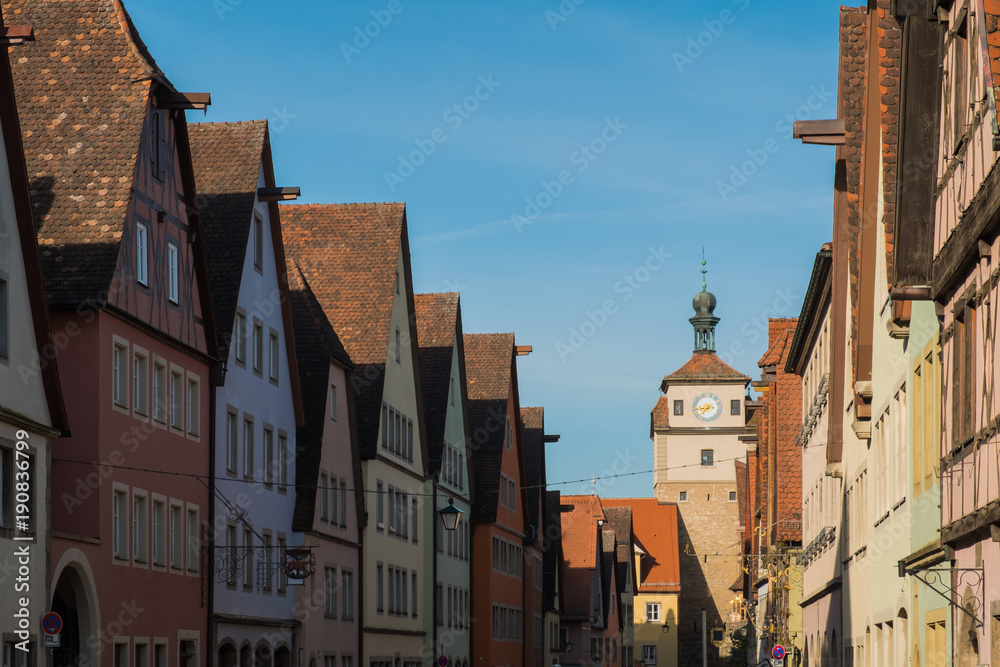 Colorful building and clock tower in old street of Rothenburg ob der Tauber, Bavaria, Germany.