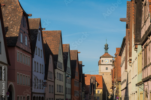 Colorful building and clock tower in old street of Rothenburg ob der Tauber, Bavaria, Germany.