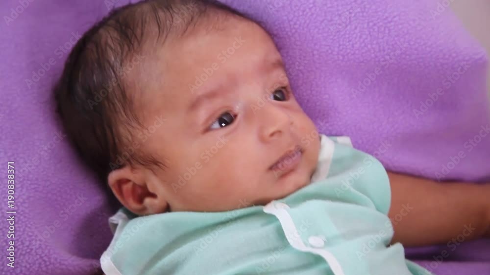 Newborn baby closeup,playful,active,smiling Newborn baby closeup,playful,active,smiling
