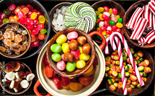 sweets candy, candied fruits with marshmallow and jelly on a wooden tray.