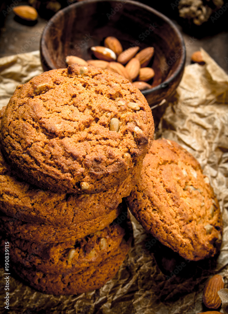 Oatmeal cookies in a bowl with nuts.
