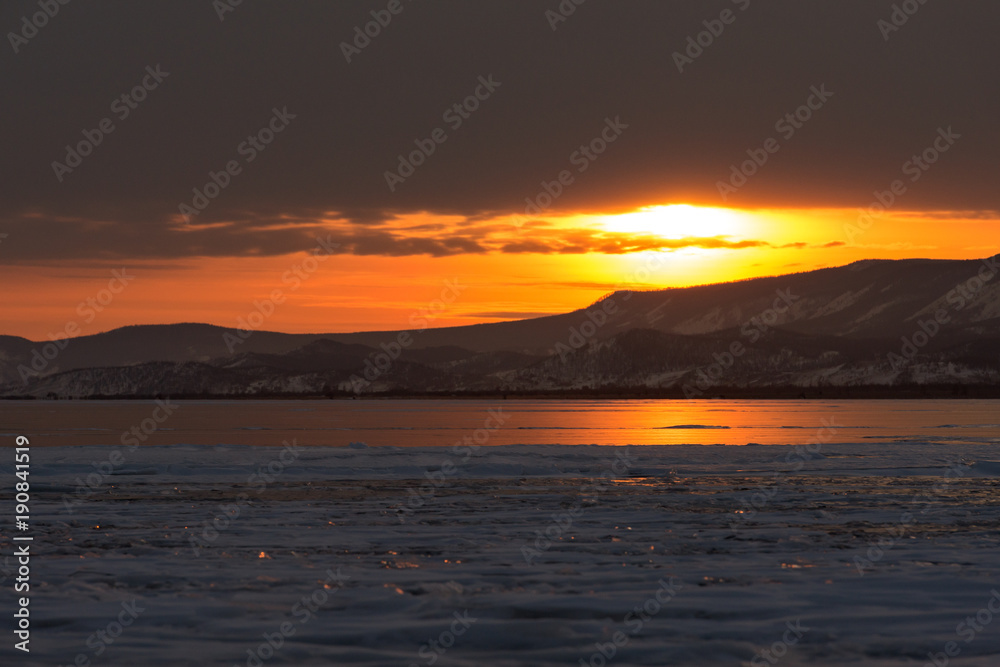 The reflection of sunset on winter lake Baikal	