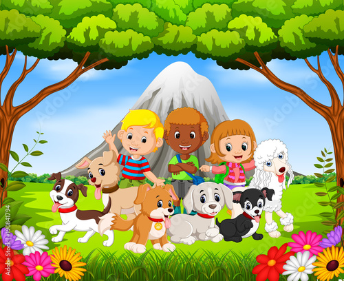 Kids and their pet dogs in the park with mountain scene