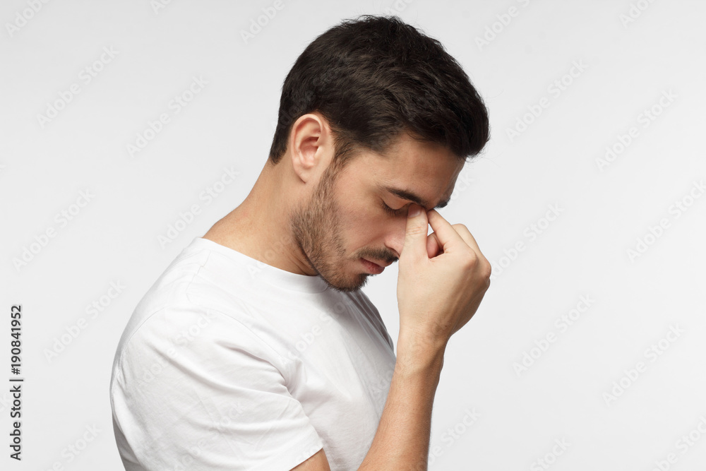 Young man crying about his failure, feeling bad about unpleasant situation. Negative emotion concept. Young man crying about his failure, feeling bad about unpleasant situation. Negative emotion concept.