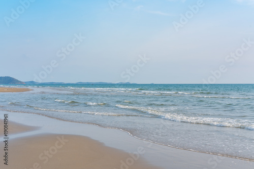 Surf wave is covering a sea beach sand