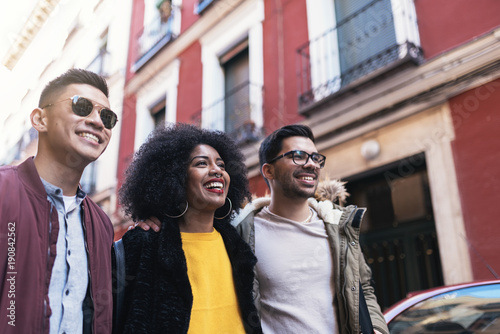 Group of happy friends walking in the street.