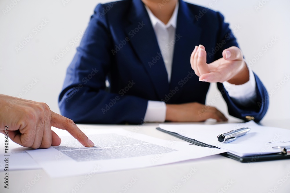 Sales manager giving advice application form document, considering mortgage loan offer for car and house insurance. Sales manager giving advice application form document, considering mortgage loan offer for car and house insurance.