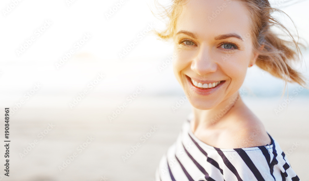 happy woman enjoying freedom and laughs on sea - obrazy, fototapety, plakaty 