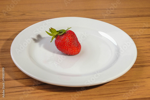 Fresh strawberry on a white plate