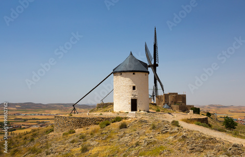 CONSUEGRA, SPAIN . JUNE 24, 2016 Group of windmills in Campo de Criptana and Castillo de la Muela on the background. La Mancha, Consuegra, Don Quixote route, Spain, Europe