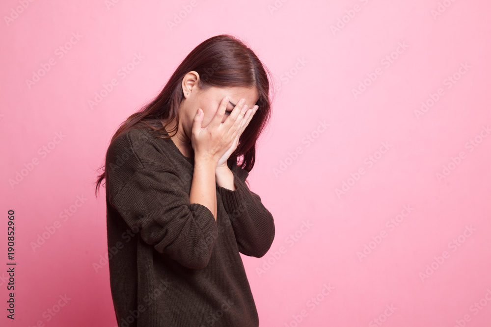 Sad young Asian woman cry with palm to face. Sad young Asian woman cry with palm to face.