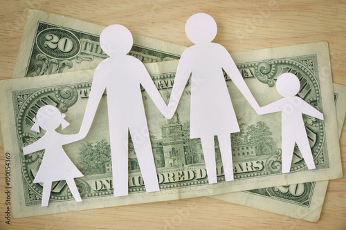 Paper family cut-out on dollars banknotes - Family budget concept
