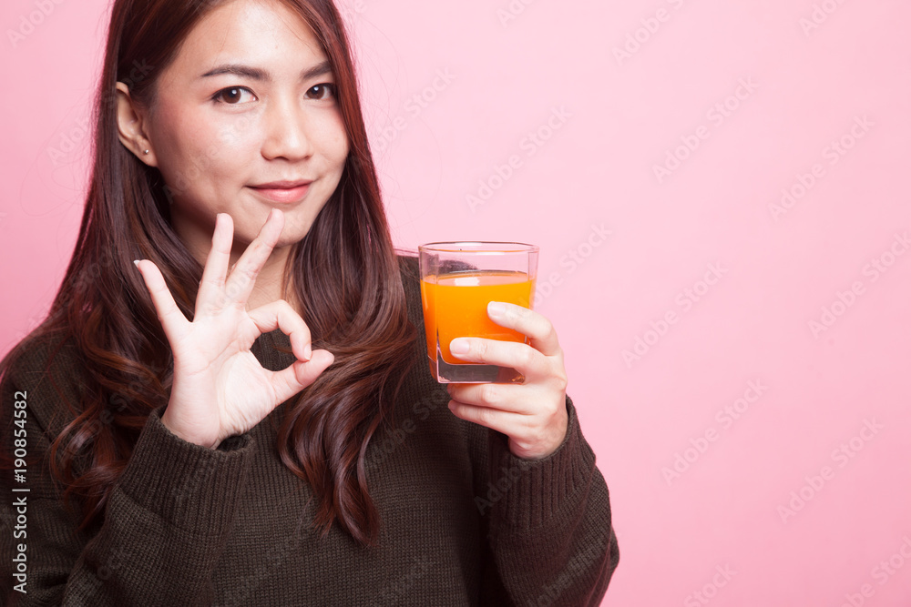 Young Asian woman show OK drink orange juice. Young Asian woman show OK drink orange juice.