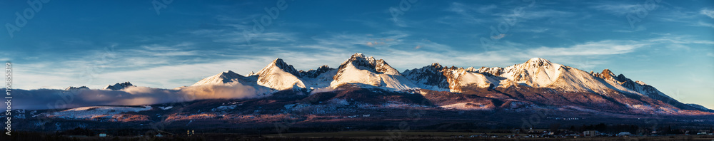 Panoramic shot of winter mountain landscape during sunset. High Tatras, Slovakia, from Poprad
