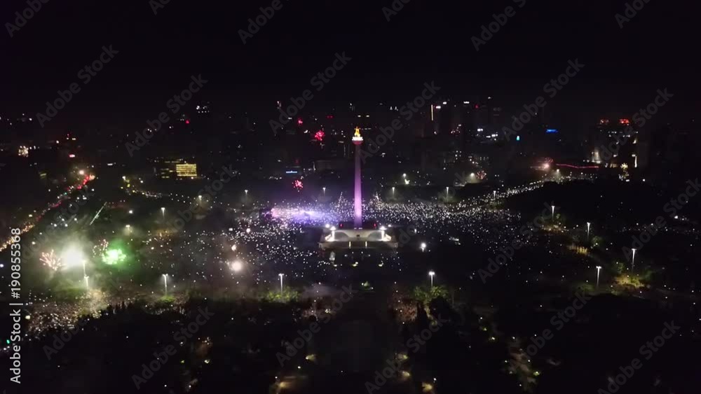National Monument Jakarta with fireworks at 2018 new year celebration National Monument Jakarta with fireworks at 2018 new year celebration