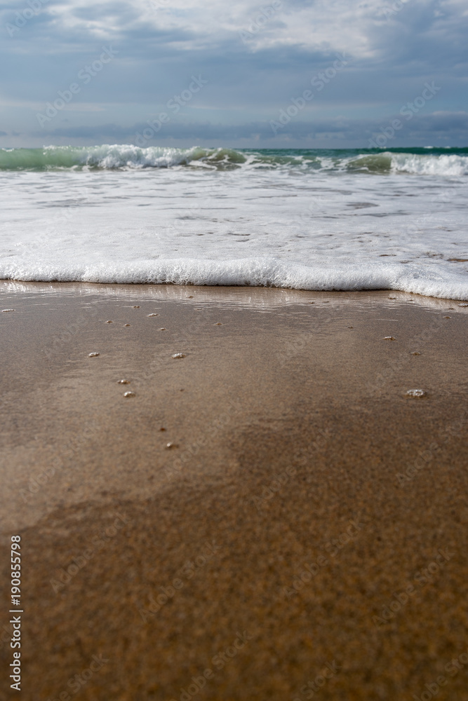 Foamy atlantic ocean wave on beach sand. Foamy atlantic ocean wave on beach sand.