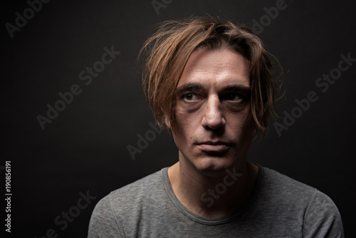 Cuadro en lienzo Portrait of unhappy hophead standing and looking aside with melancholy