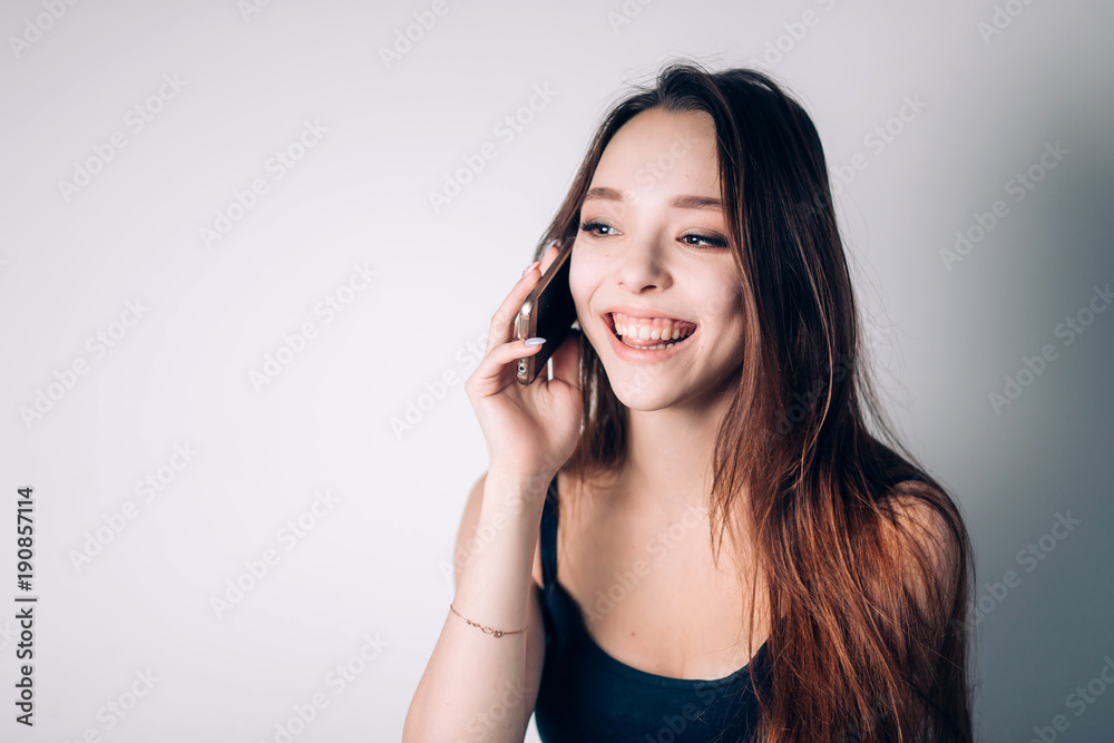 Girl calling on phone at home. Happy woman uses a smartphone Girl calling on phone at home. Happy woman uses a smartphone