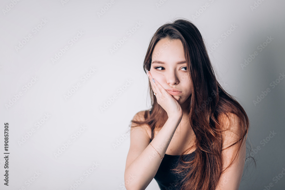 Beautiful woman suffering from severe tooth pain, holding his cheek on his hand. Painful face, pain, dentistry. Beautiful woman suffering from severe tooth pain, holding his cheek on his hand. Painful face, pain, dentistry.