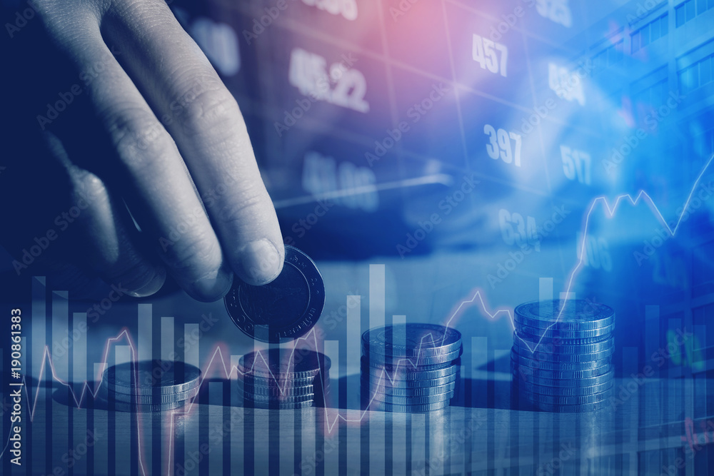 Graph on rows of coins for finance and Saving money on digital stock market financial exchange and Trading graph Double exposure city on the background Graph on rows of coins for finance and Saving money on digital stock market financial exchange and Trading graph Double exposure city on the background