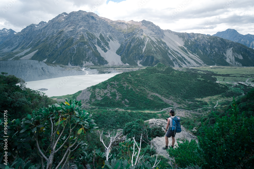 2018, JAN 8 - New Zealand, Mt Cook Nationalpark, A man Traveler looking for a stunning view of the nature while tracking in Muller's hut track 2018, JAN 8 - New Zealand, Mt Cook Nationalpark, A man Traveler looking for a stunning view of the nature while tracking in Muller's hut track