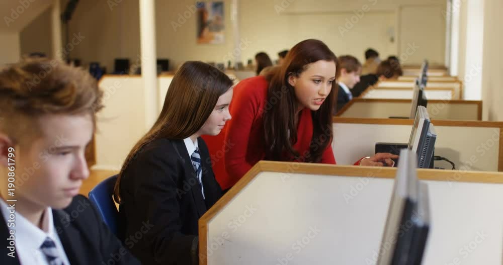 4k, Teacher helping a girl in a computer class.Slow motion 4k, Teacher helping a girl in a computer class.Slow motion