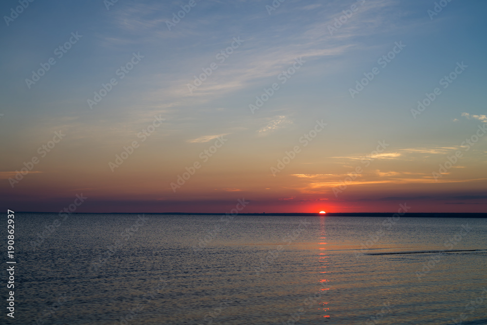 Fototapeta premium Sunset on beach on Baltic sea with calm water