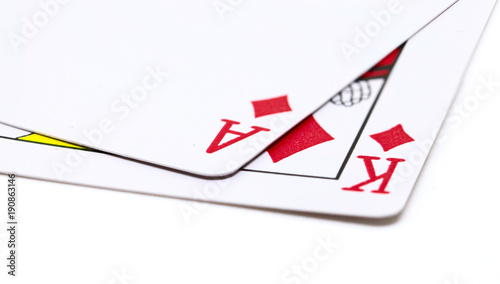 Two playing cards on white background. Poker hand with diamond ace and king. photo