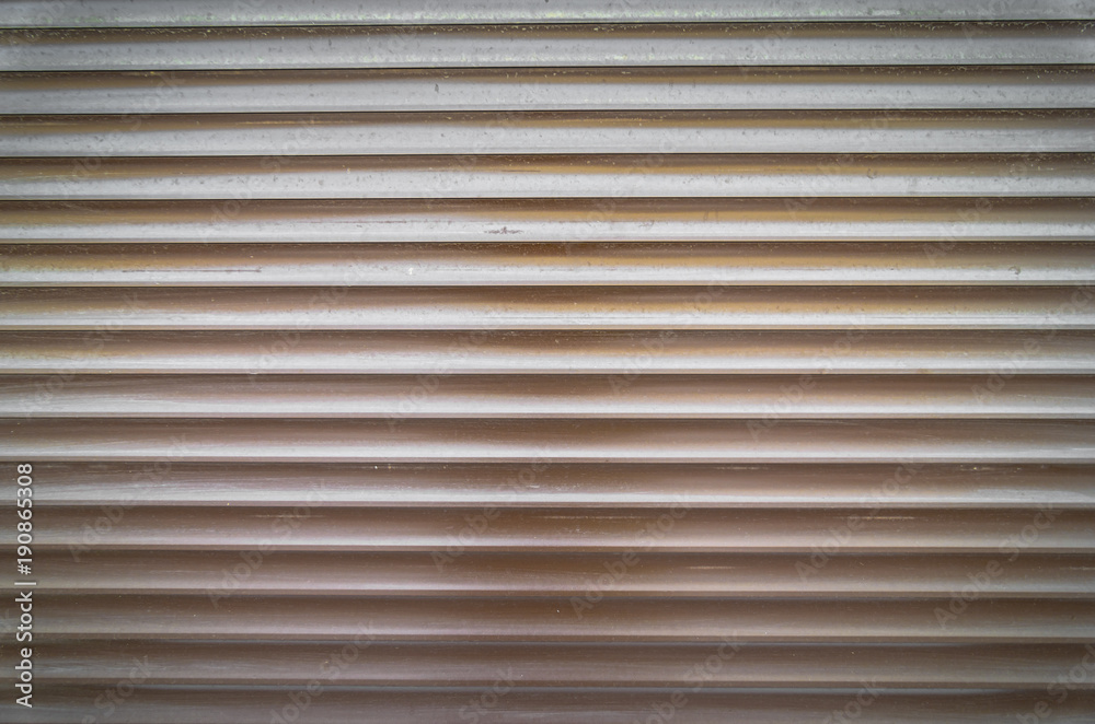 Teal brown painted horizontal metal window roller shutter blinds or garage doors background texture Teal brown painted horizontal metal window roller shutter blinds or garage doors background texture
