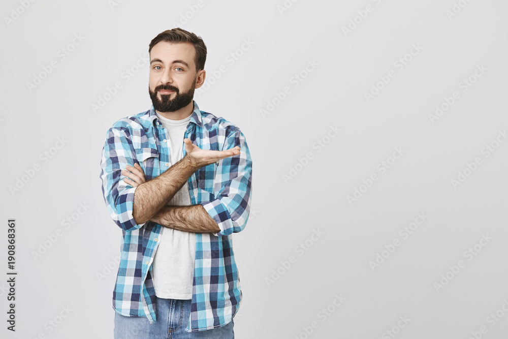 Portrait of handsome european bearded businessman showing get to the point gesture with crossed hand and pointed palm, over gray background. Guy tries to understand what his friend want to say