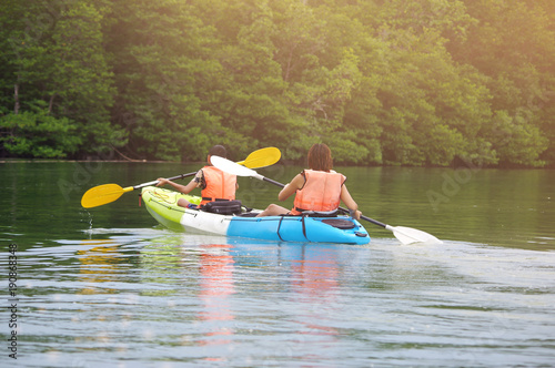 Family on kayaks canoe tour and morning light