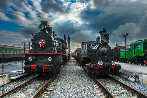 An old steam locomotive. Two black locomotives. Railway. An old railway with locomotives.