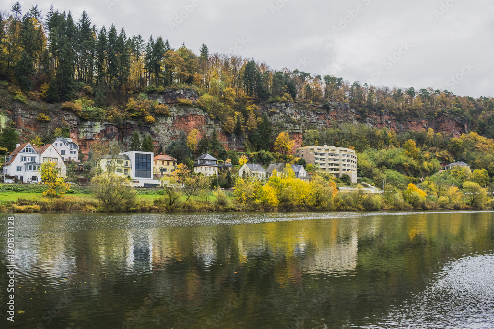 Fototapeta premium Detail of Moselle river valley with typical village houses near Trier in rainy day in November, Germany. Dark autumn landscape.