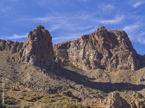 view on famous rock formation cathedral in Roques de Garcia and colorful volcanic mountain and lava desert on tenerife canary island unesco protected landscape, blue sky background © Kristyna