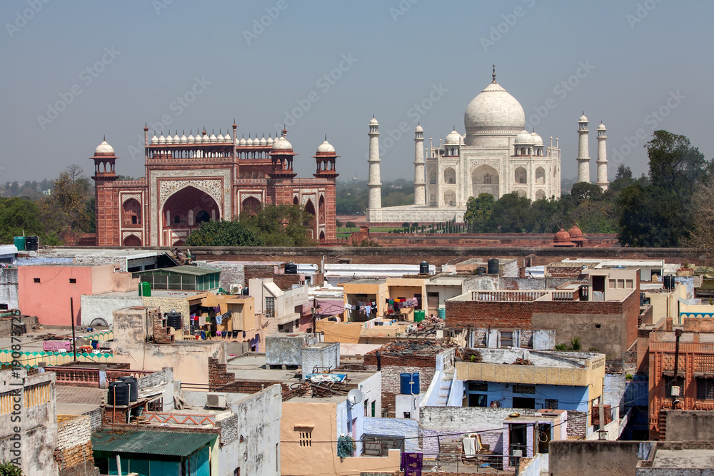 View to Taj Mahal and poor neighborhood buildings, Agra, India