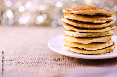 Fried pancakes are a mountain on a plate of sweets