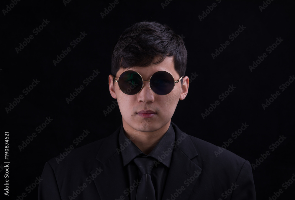 Obraz premium Portrait of a young Asian man. Close-up face on a black background