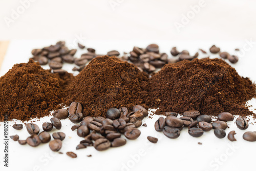 Coffee beans and powder on white background. grinding for espresso and alternative methods of brewing coffee