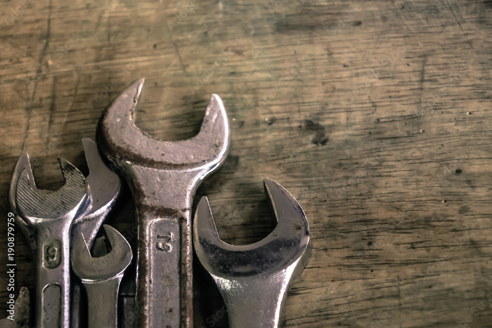 Close up wrench craftsman tool on wooden table, vintage style Close up wrench craftsman tool on wooden table, vintage style