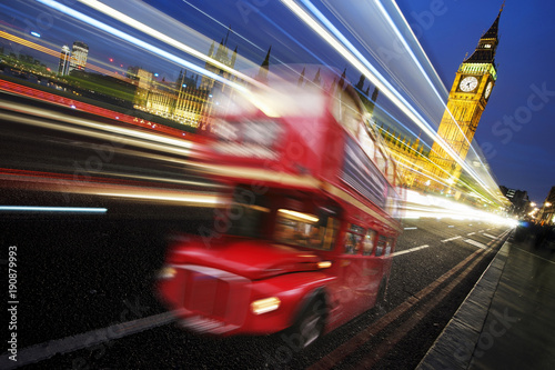 Fototapeta UK - Cities - Scene of Westminster Bridge at night seen from South Bank, fast moving routemaster bus present