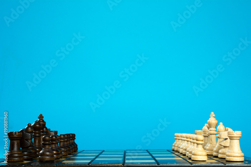 chess game, chess board with placed figures, blue background © SecondSide